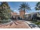 Luxurious clubhouse entrance with a brick-paved drive, stucco facade, and well-manicured landscaping at 1227 Toscano Dr, Trinity, FL 34655