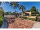 Elegant community entrance with wrought iron gates, a brick-paved drive, and meticulously maintained landscaping at 1227 Toscano Dr, Trinity, FL 34655