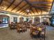 Elegant community dining room featuring wood ceilings, ornate chandeliers, and comfortable seating at 1227 Toscano Dr, Trinity, FL 34655