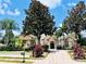 Charming single-story home with stone accents, mature trees, and a well-manicured lawn at 1227 Toscano Dr, Trinity, FL 34655