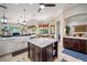 Open kitchen with an island, a farmhouse sink, and granite countertops at 1227 Toscano Dr, Trinity, FL 34655