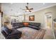 A living room with a leather sectional and a view into the kitchen at 1227 Toscano Dr, Trinity, FL 34655