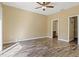 Bright bedroom featuring hard surface floors, and a ceiling fan at 5723 Autumn Shire Dr, Zephyrhills, FL 33541