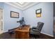 Home office features hardwood floors, built-in desk, and comfortable seating at 1227 Toscano Dr, Trinity, FL 34655