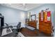 Well-lit bedroom featuring a desk, dresser, and wooden wardrobe at 1227 Toscano Dr, Trinity, FL 34655