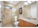 Bathroom features a walk-in shower with decorative tile and granite vanity at 1227 Toscano Dr, Trinity, FL 34655