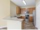 Kitchen features wood cabinets, stainless steel appliances, and a breakfast bar at 5723 Autumn Shire Dr, Zephyrhills, FL 33541