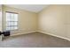 Well-lit bedroom with carpeted floors and window at 5723 Autumn Shire Dr, Zephyrhills, FL 33541