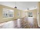 Spacious living room featuring wood-look floors and sliding glass doors at 5723 Autumn Shire Dr, Zephyrhills, FL 33541