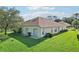 Backyard with a patio and well-maintained lawn at 5723 Autumn Shire Dr, Zephyrhills, FL 33541