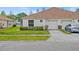 Front view of a house with a garage and landscaped yard at 5723 Autumn Shire Dr, Zephyrhills, FL 33541