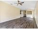 Bright and airy living room with wood-look floors at 5723 Autumn Shire Dr, Zephyrhills, FL 33541