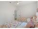 Charming bedroom with two twin beds featuring floral bedding and ample closet space at 13231 Snowy Plover Ave, Weeki Wachee, FL 34614