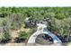 House with circular driveway and fountain in a wooded area at 13231 Snowy Plover Ave, Weeki Wachee, FL 34614