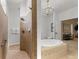 Large bathroom with a walk-in shower, soaking tub, and separate toilet area at 13231 Snowy Plover Ave, Weeki Wachee, FL 34614