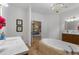Spa-like bathroom with a soaking tub, vanity, and views into the bedroom at 13231 Snowy Plover Ave, Weeki Wachee, FL 34614