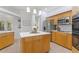 Modern kitchen with stainless steel appliances and light wood cabinets at 13231 Snowy Plover Ave, Weeki Wachee, FL 34614