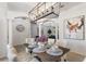 Bright dining room features a wood table, chandelier, and artwork at 13231 Snowy Plover Ave, Weeki Wachee, FL 34614