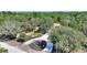 House with circular driveway and fountain, tree-lined lot at 13231 Snowy Plover Ave, Weeki Wachee, FL 34614