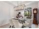 Dining area with farmhouse table and chandelier at 13231 Snowy Plover Ave, Weeki Wachee, FL 34614