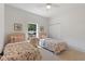 Well-lit bedroom with two twin beds, featuring floral bedding and a window at 13231 Snowy Plover Ave, Weeki Wachee, FL 34614