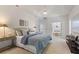 Spacious main bedroom with a large bed, ensuite bathroom, and ample natural light at 13231 Snowy Plover Ave, Weeki Wachee, FL 34614