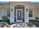 Front entry with screen door and architectural details at 13231 Snowy Plover Ave, Weeki Wachee, FL 34614