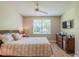 Spacious bedroom with large window, ceiling fan, and dresser at 2346 Nantucket Dr # 58, Sun City Center, FL 33573