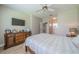 Bright bedroom with a dresser, ceiling fan, and en-suite bathroom access at 2346 Nantucket Dr # 58, Sun City Center, FL 33573