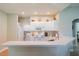 White kitchen cabinets, updated appliances, and a breakfast bar at 2346 Nantucket Dr # 58, Sun City Center, FL 33573