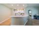 Kitchen with white cabinets, breakfast bar, and view to living room at 2346 Nantucket Dr # 58, Sun City Center, FL 33573