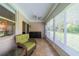 Bright sunroom with wicker chair and view of green space at 2346 Nantucket Dr # 58, Sun City Center, FL 33573