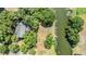 An aerial view shows the layout of the property, its proximity to a pond and the surrounding greenery and trees at 6605 Pemberton Sage Ct, Seffner, FL 33584