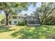 Large backyard includes well-kept lawn, mature trees, swing set, and porch at 6605 Pemberton Sage Ct, Seffner, FL 33584