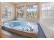 Bathroom featuring a luxurious soaking tub surrounded by tile at 6605 Pemberton Sage Ct, Seffner, FL 33584