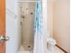 Bathroom featuring a tiled shower with curtain and standard toilet at 6605 Pemberton Sage Ct, Seffner, FL 33584