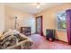 Cozy bedroom includes a sofa, bookshelf, mini-fridge, window and an exterior door at 6605 Pemberton Sage Ct, Seffner, FL 33584