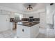 Kitchen with a center island, granite countertops, white cabinets, and stainless steel appliances at 6605 Pemberton Sage Ct, Seffner, FL 33584