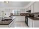 Eat-in kitchen featuring updated appliances, light colored cabinets, and views of the backyard at 6605 Pemberton Sage Ct, Seffner, FL 33584