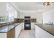 Updated kitchen featuring granite countertops, stainless steel appliances, and a stone backsplash at 6605 Pemberton Sage Ct, Seffner, FL 33584