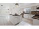 Bright kitchen featuring a center island, granite countertops, and white cabinets at 6605 Pemberton Sage Ct, Seffner, FL 33584