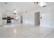 Open concept living room featuring white tile floors and views into the kitchen at 6605 Pemberton Sage Ct, Seffner, FL 33584