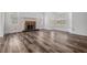 Spacious living room featuring a brick fireplace, new flooring, and ample natural light at 6605 Pemberton Sage Ct, Seffner, FL 33584