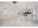 Open living space with tile flooring, modern lighting, and access to the kitchen area at 6605 Pemberton Sage Ct, Seffner, FL 33584
