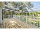 Spacious covered patio with wood decking, a metal safety fence, and outdoor views at 6605 Pemberton Sage Ct, Seffner, FL 33584