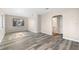Living room with built-in shelves and wood-look floors at 2504 38Th W Ave, Bradenton, FL 34205