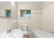 Clean bathroom with a tub, toilet and sink at 2504 38Th W Ave, Bradenton, FL 34205