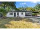 Newly renovated home featuring a white exterior, dark-grey accents and a carport at 2504 38Th W Ave, Bradenton, FL 34205