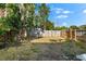 Large backyard with a wooden fence and gravel area at 2504 38Th W Ave, Bradenton, FL 34205