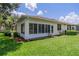 Single-story home with a large sunroom and well-manicured lawn at 2346 Nantucket Dr # 58, Sun City Center, FL 33573